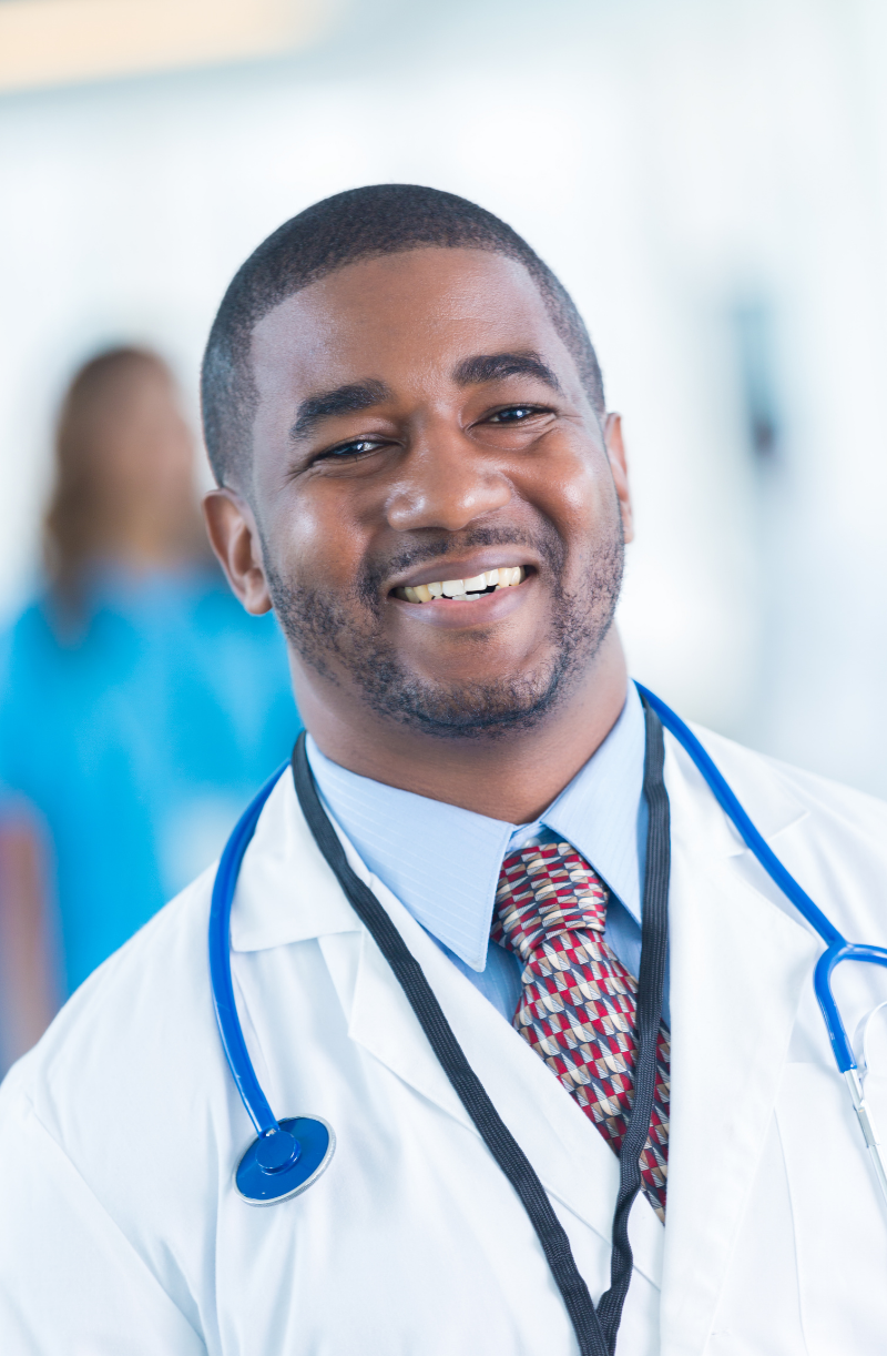 Male doctor in white coat with a blue stethoscope around his neck