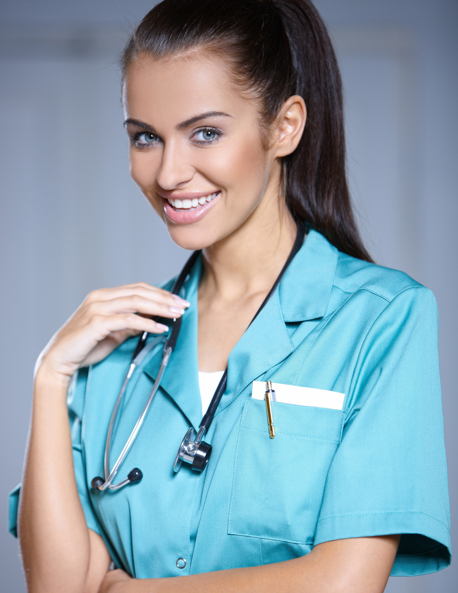 Female doctor in blue scrubs with a stethoscope around her neck