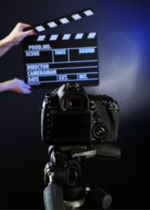 A camera with a clapperboard in front of it