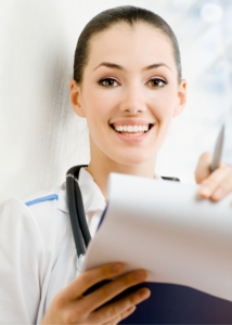 A female doctor smiling holding paper