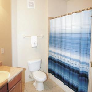 Interior image of a bathroom with a blue and white shower curtain