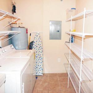 Interior image of a laundry room with white appliances